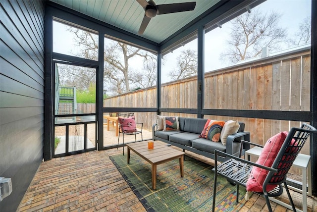 sunroom featuring ceiling fan