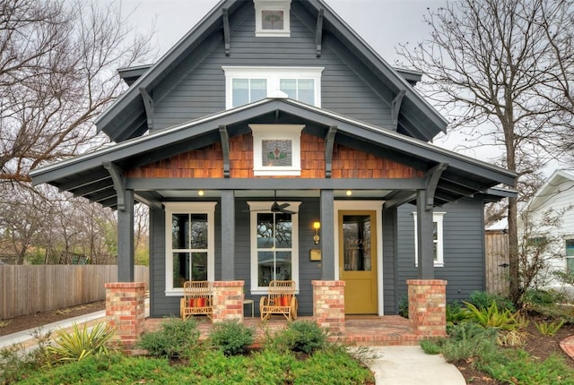 view of front facade featuring covered porch and fence