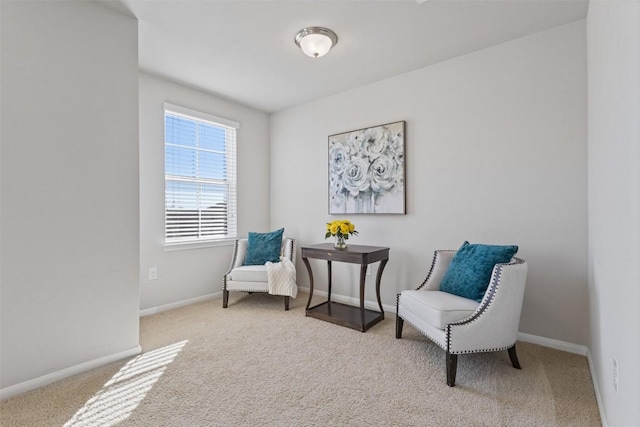 sitting room featuring carpet floors and baseboards