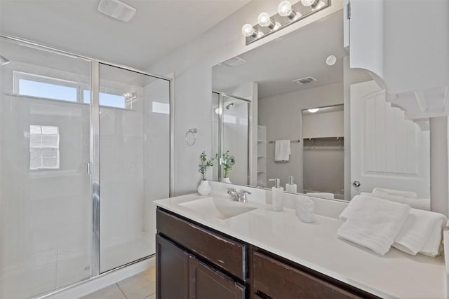 bathroom featuring a stall shower, tile patterned flooring, visible vents, and vanity