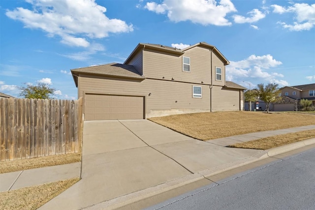 view of front of property with a garage, fence, and driveway