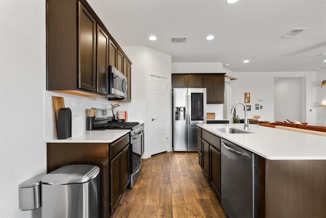 4709 Oxgang Dr, Pflugerville, TX 78660 - kitchen with dark brown cabinetry, a sink, visible vents, and stainless steel appliances