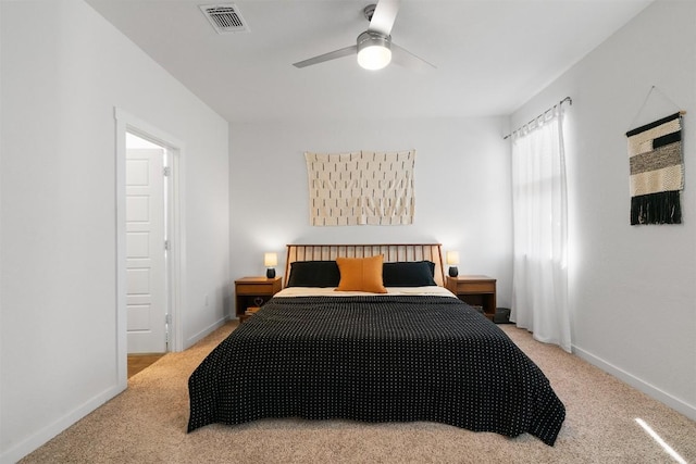 carpeted bedroom with visible vents, ceiling fan, and baseboards