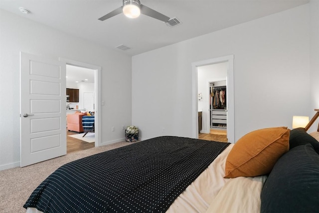 bedroom featuring light colored carpet, visible vents, and baseboards