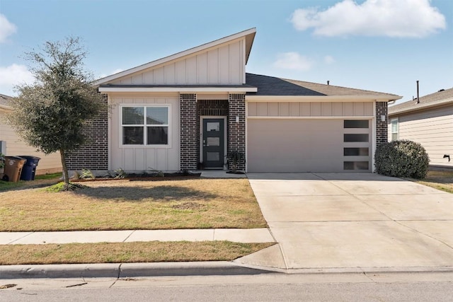 view of front of house featuring a garage, brick siding, concrete driveway, board and batten siding, and a front yard