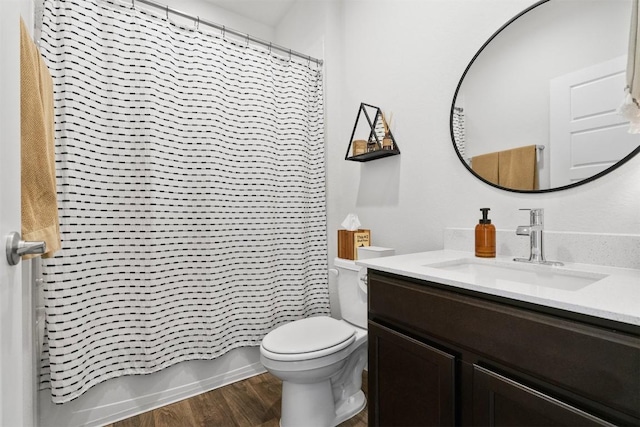 bathroom featuring toilet, shower / tub combo, wood finished floors, and vanity