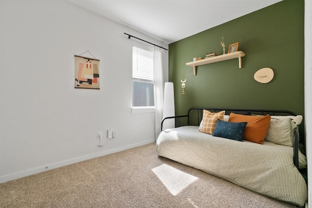 bedroom featuring carpet and baseboards