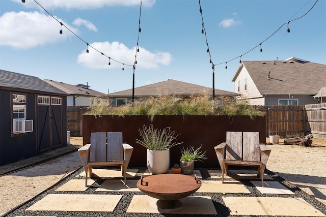 view of patio featuring cooling unit, fence, and an outdoor structure