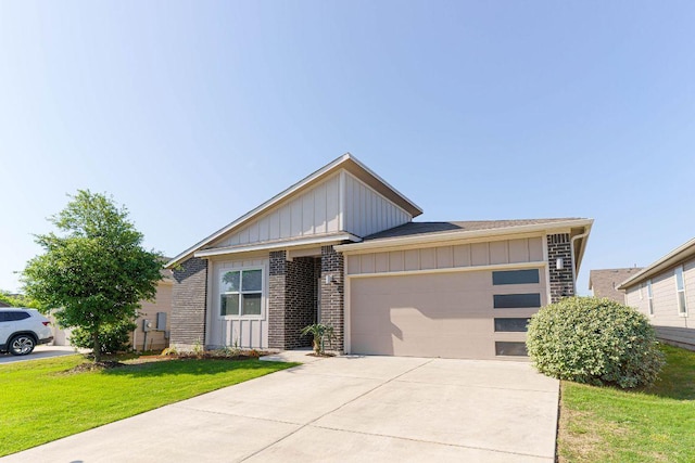 4709 Oxgang Dr, Pflugerville, TX 78660 - view of front of house with a front yard, a garage, board and batten siding, brick siding, and driveway