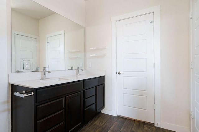4709 Oxgang Dr, Pflugerville, TX 78660 - full bathroom with wood finished floors, double vanity, a sink, and baseboards