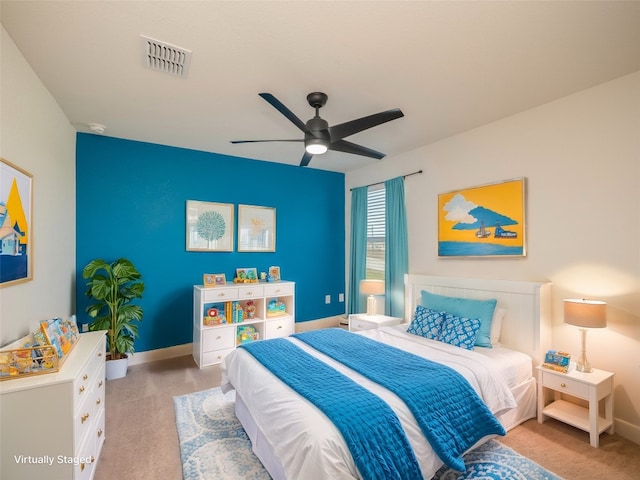 bedroom featuring light carpet, a ceiling fan, visible vents, and baseboards