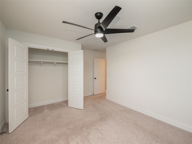 unfurnished bedroom featuring a closet, carpet flooring, visible vents, and baseboards