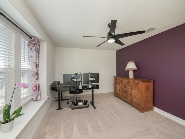 office featuring a ceiling fan, carpet flooring, visible vents, and baseboards