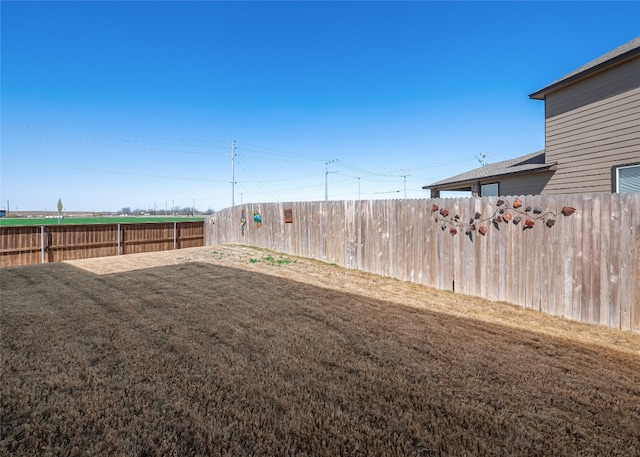 view of yard with a fenced backyard