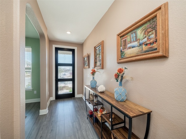 entryway with dark wood-style floors and baseboards