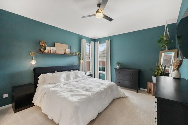 bedroom with light carpet, ceiling fan, and baseboards