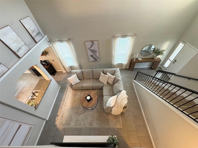 living area with stairway and a high ceiling