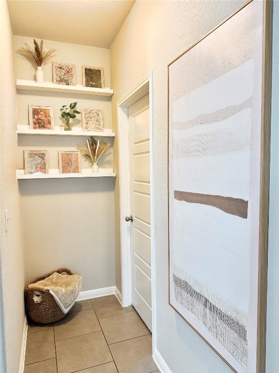 mudroom featuring baseboards and light tile patterned floors