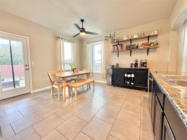 dining room with light tile patterned flooring, a ceiling fan, and baseboards