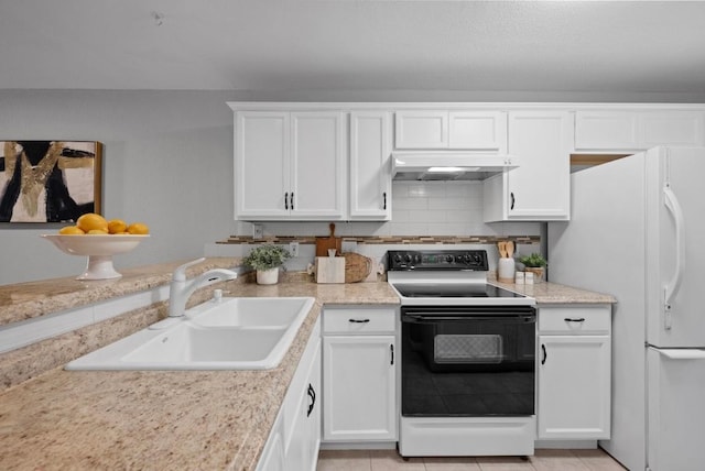 kitchen featuring black electric range, freestanding refrigerator, white cabinetry, a sink, and exhaust hood