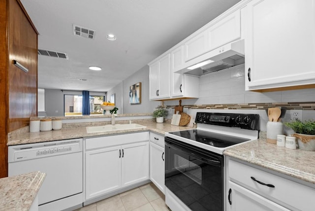 kitchen featuring electric stove, white dishwasher, visible vents, and under cabinet range hood