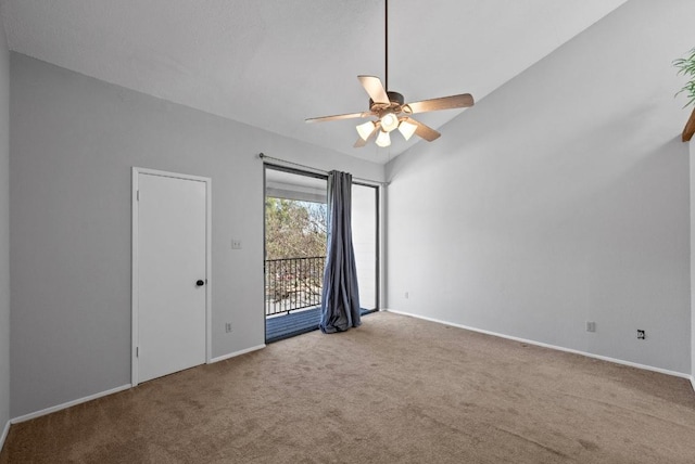 spare room with a ceiling fan, carpet flooring, vaulted ceiling, and baseboards