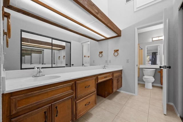 full bathroom with tile patterned flooring, a sink, baseboards, and double vanity