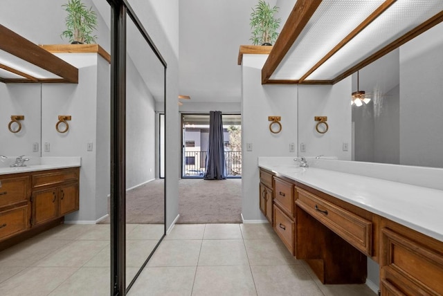 full bath with tile patterned flooring, baseboards, and vanity