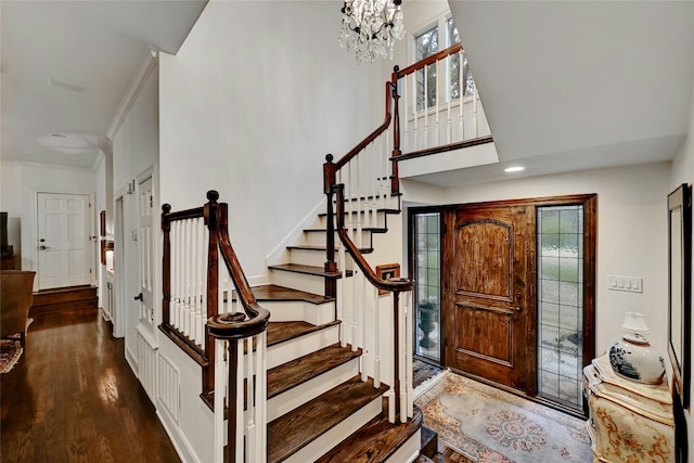 2405 Westlake Pass, Austin, TX 78746 - entrance foyer featuring wood finished floors, stairs, a chandelier, ornamental molding, and a high ceiling