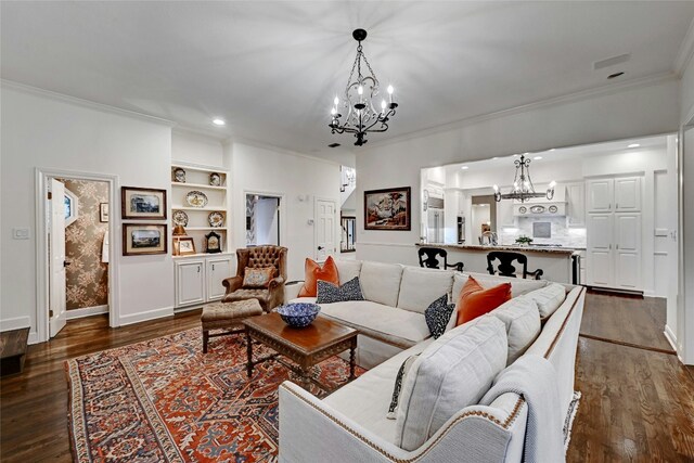living room with crown molding, an inviting chandelier, baseboards, and dark wood finished floors