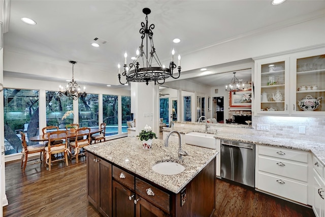 kitchen with a chandelier, stainless steel dishwasher, dark brown cabinets, and a sink