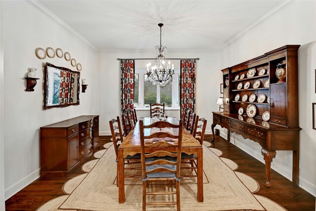 dining room with ornamental molding, wood finished floors, visible vents, and a notable chandelier