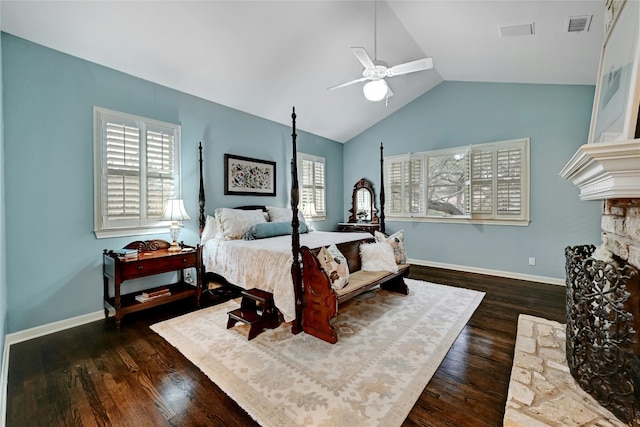 bedroom featuring vaulted ceiling, visible vents, a fireplace, and wood finished floors