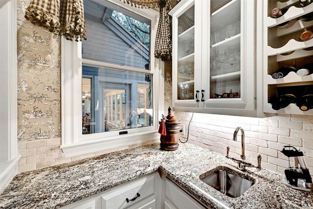 bar with backsplash and a sink