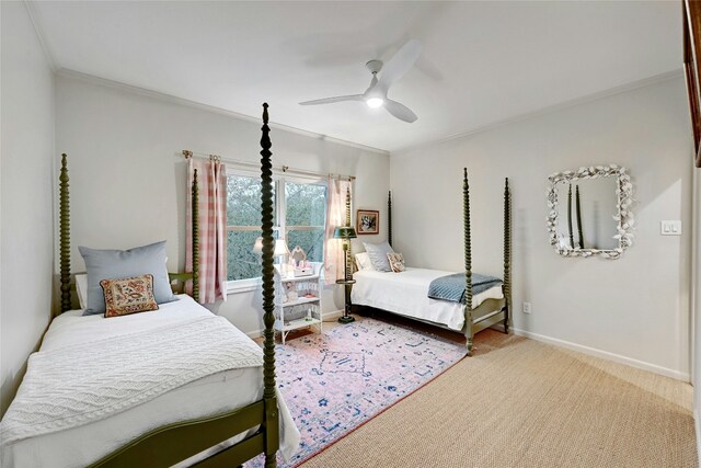 carpeted bedroom featuring baseboards, ornamental molding, and a ceiling fan