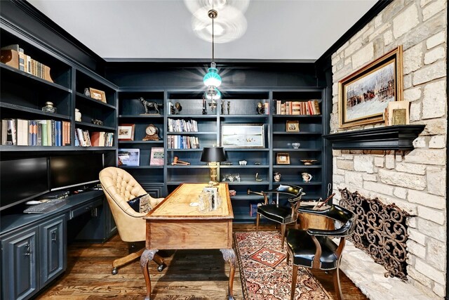 office area with ornamental molding, wood finished floors, built in features, and built in study area