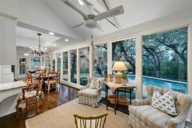 sunroom / solarium featuring recessed lighting, wood finished floors, a notable chandelier, and lofted ceiling