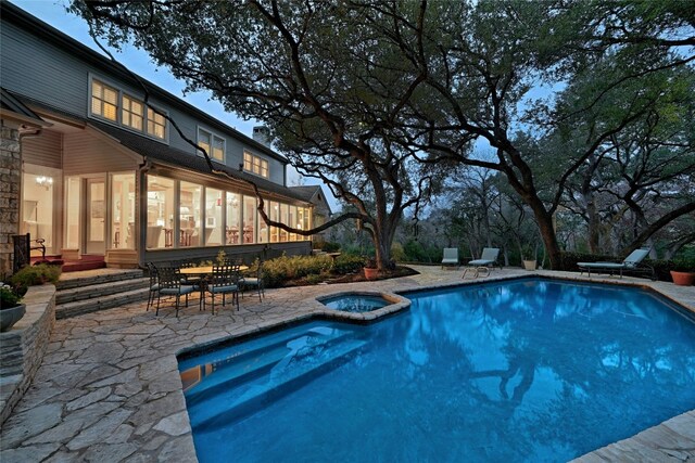 view of pool featuring a patio and a pool with connected hot tub