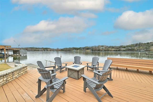 dock area with an outdoor fire pit and a water view