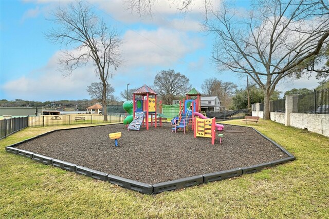 community playground with a yard and fence