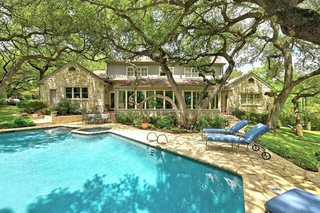 view of pool featuring a pool with connected hot tub and a patio area