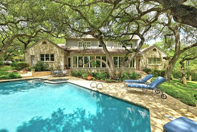 2405 Westlake Pass, Austin, TX 78746 - back of property featuring a patio, a pool with connected hot tub, and stone siding