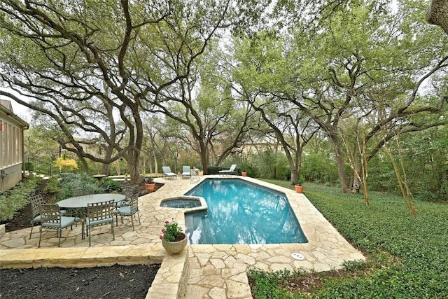 view of pool featuring a pool with connected hot tub and a patio area