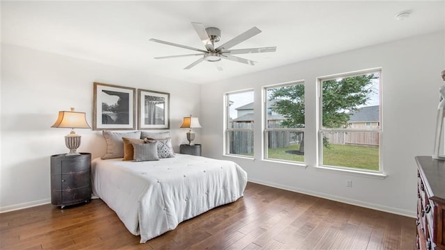 112 Amber Oak Ln, Georgetown, TX 78628 - bedroom with baseboards, wood finished floors, and a ceiling fan