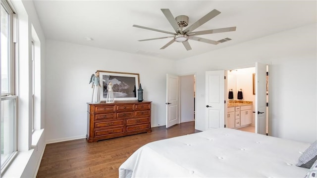 112 Amber Oak Ln, Georgetown, TX 78628 - bedroom featuring wood finished floors, ensuite bathroom, a ceiling fan, and baseboards