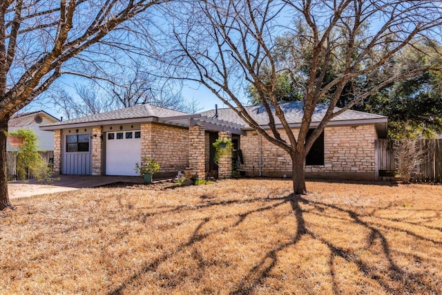 single story home with stone siding, fence, and an attached garage