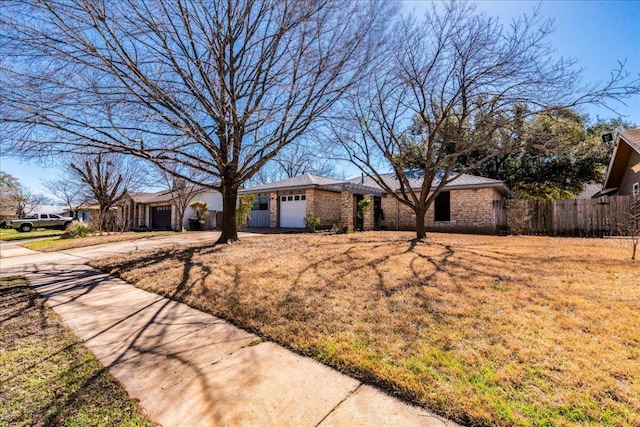 ranch-style house with a garage, concrete driveway, a front lawn, and fence