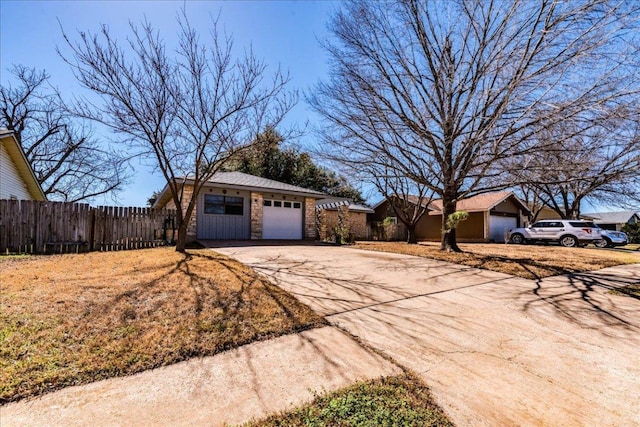 exterior space with concrete driveway and fence