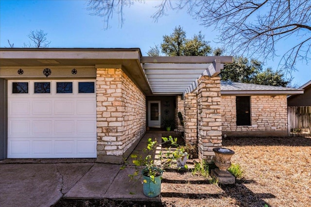 view of front of house with a garage and stone siding