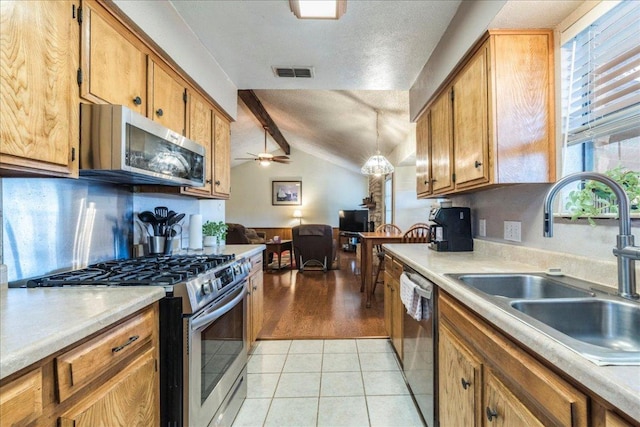 kitchen featuring light tile patterned floors, visible vents, appliances with stainless steel finishes, light countertops, and a sink